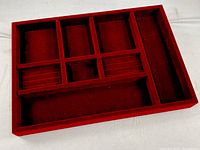 Top view of maroon velvet jewelry tray showing compartments