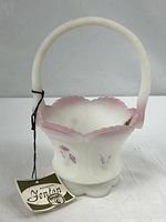 Full view showing basket shape, handle, hang tag