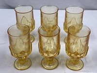 Six yellow iced tea goblets grouped