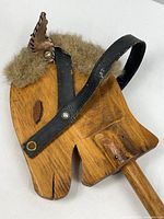 Close view of wood horse head with leather bridle, faux fur mane, leather ear