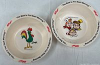 Both bowls side by side showing interior graphics and rim text