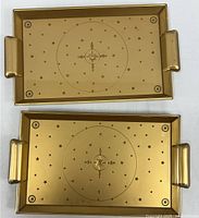 Two identical gold plastic trays side by side