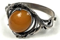 Front view showing amber cabochon and floral sterling setting