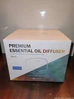 Front of sealed retail box showing product name, capacity, Tuya app logo