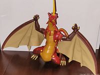 Front left view of Bakugan Drago figure showing fabric wings and articulated limbs
