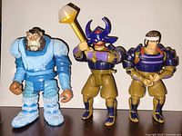 Three Thundercats figures standing—Snowman, Hachiman with helmet, Hachiman without helmet