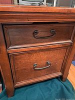 Front view of one end table showing two drawers and handles