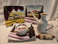 Entire lot showing plates, dipping dishes, oil carafe and rolling-pin card holder