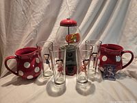 Group shot showing four Betty Boop glasses, two red polka dot pitchers, Jelly Belly candy dispenser, Betty Boop magnet