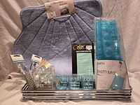 Full lot showing all packaged bathroom items arranged on stainless tray