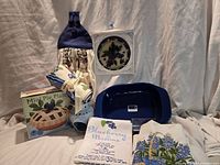 Group shot of all items including baking dish, boxed pie plate, towels, wax warmer, suncatcher