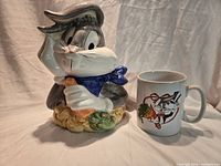 Cookie jar and oversized mug side by side showing Bugs Bunny designs