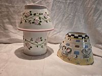 Rose motif candle holder base and shade stacked beside patchwork mouse shade