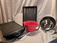 Group shot of T-Fal Excelia electric grill, two stainless bowls, red melamine pitcher-style bowl