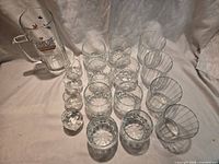 Full set of Crown Royal glasses and Sam Adams mug on white backdrop