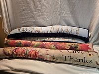 All four draft stoppers stacked to display texts and prints