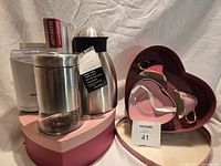 All items grouped showing grinder, jug, frother box, cup sets in heart box, glass canister