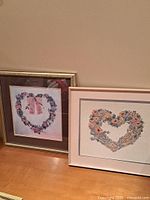 Both framed heart artworks side by side