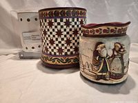 Group photo showing all three warmers: two Jim Shore ceramic pieces and boxed Home Scents warmer