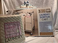 Boxed laundry sorter cart, packaged oversized tote, and hanger sign grouped