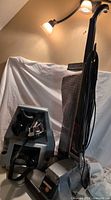 Kirby Heritage II vacuum next to grey accessory caddy with hose and attachments visible