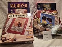 Front view of four boxed Bepuzzled mystery puzzles and game