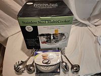 Boxed stainless steel multi-cooker set, Progressive grater set packaging, four stainless utensils arranged in front