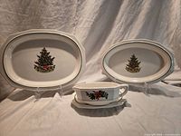 Front view showing two oval platters and gravy boat with underplate, Christmas Heritage pattern
