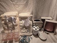 Full lot showing towel sets, tissue cover, night-lights, votive holders, ceramic bath pieces, shower hooks