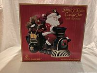 Front of unopened box showing Santa's Train Cookie Jar graphic and branding