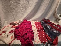 Five assorted scarves laid out showing patterns and colours
