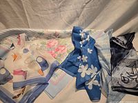 All five scarves displayed side by side showing patterns and colours