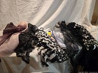 All eight scarves laid out showing colors, patterns and fabric textures