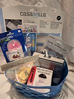 Group shot of all seven packaged sink and dish cleaning items in blue plastic tote
