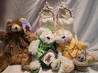 Group shot showing all teddy bears, towels, soap and basket