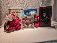 Group shot of all seven items: three books, two plush, reversible doll, boxed Ginny doll