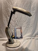 Lamp profile view with packaged spare bulb behind