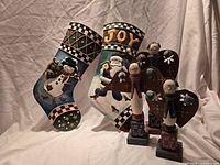 Two tin stockings and three snowman angel figurines grouped together