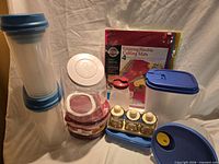 Full lot showing majority of plastic containers, jars, pitcher, bottle, small jars set, and cutting mats
