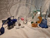 Group shot showing entire lot: tray, perfume bottles, bells, soaps, powder