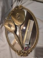 Entire 4-piece gold-plated vanity set on mirrored tray