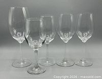 Front view of five clear wine glasses