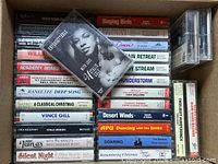 Box showing majority of cassette tapes stacked, Natalie Cole featured on top