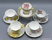 Group of five teacups and five saucers