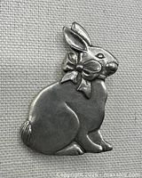 Front view of rabbit brooch showing design