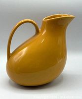 Front three-quarter view of yellow ceramic pitcher