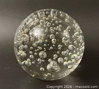 Overall view of clear glass sphere with internal bubbles