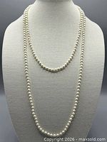 Two faux pearl necklaces displayed to show different lengths
