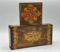 Front view of both wood boxes showing painted motifs