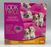 Front of sealed puzzle box showing title, puppy imagery and heart window